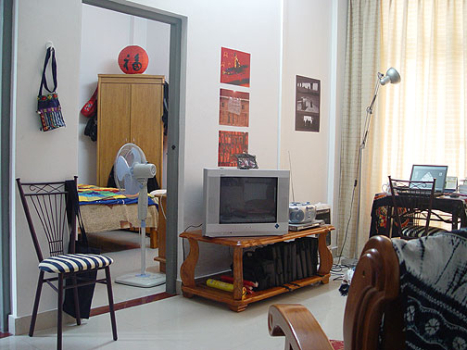 Zhaoqing University Foreign Student apartment, showing sitting room with door open to bedroom. Flats also have bathroom and kitchen 